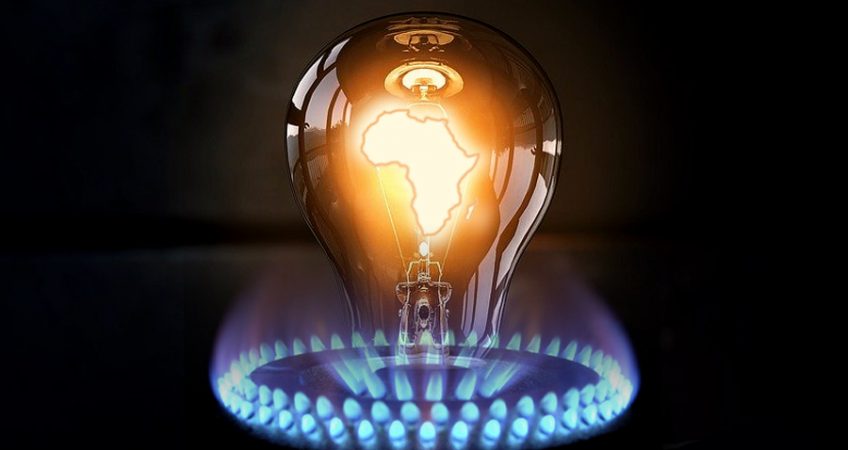 A filament lightbulb, with a glowing image of the African continent overlaid on the filament, surrounded by a lit gas hob
